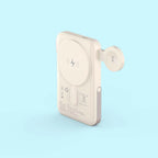 A compact, off-white portable power bank with a circular magnetic wireless charging pad on the back and an attached side connector, shown on a light blue background.