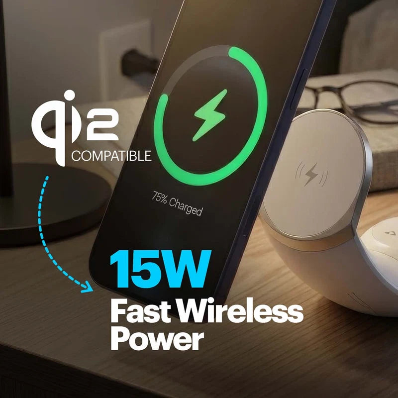 A smartphone shown at an angle on a wireless charging pad in a real indoor setting, with overlaid text reading 'Qi2 Compatible', '15W Fast Wireless Power', and a green battery icon on the phone screen. The product appears to be a wireless charging dock/stand rather than the phone itself.
