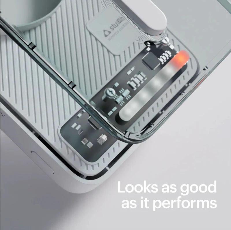 Close-up of a electronic device with a digital display on a light gray background.