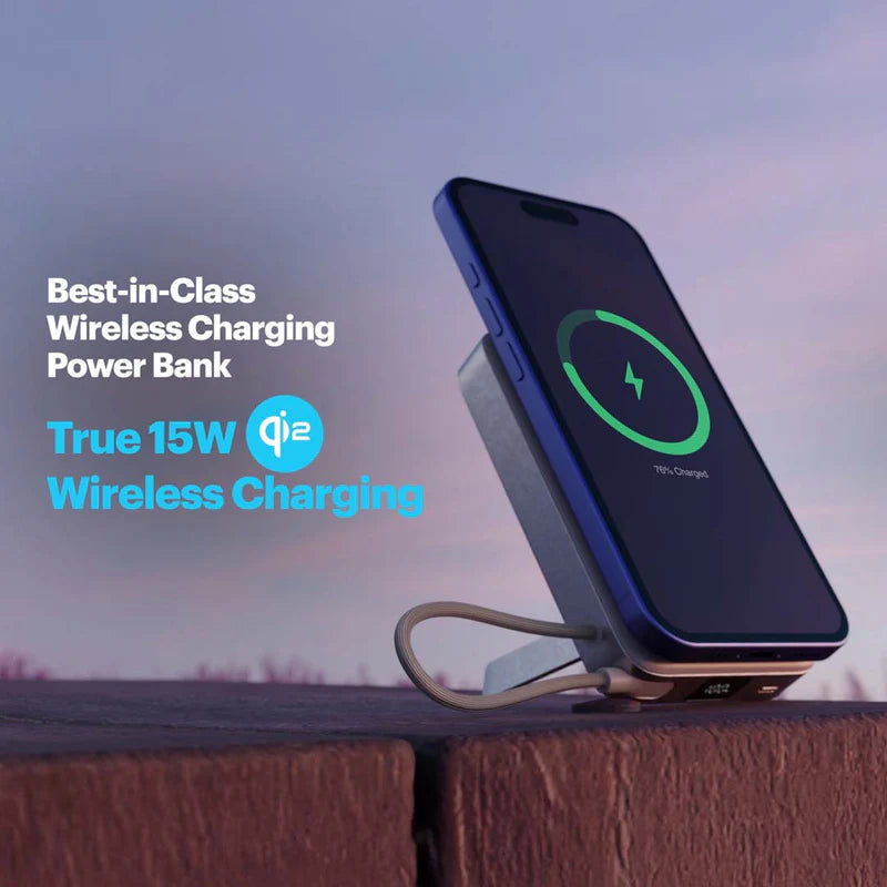 Wireless charging power bank with smartphone on a wooden surface against a sky background