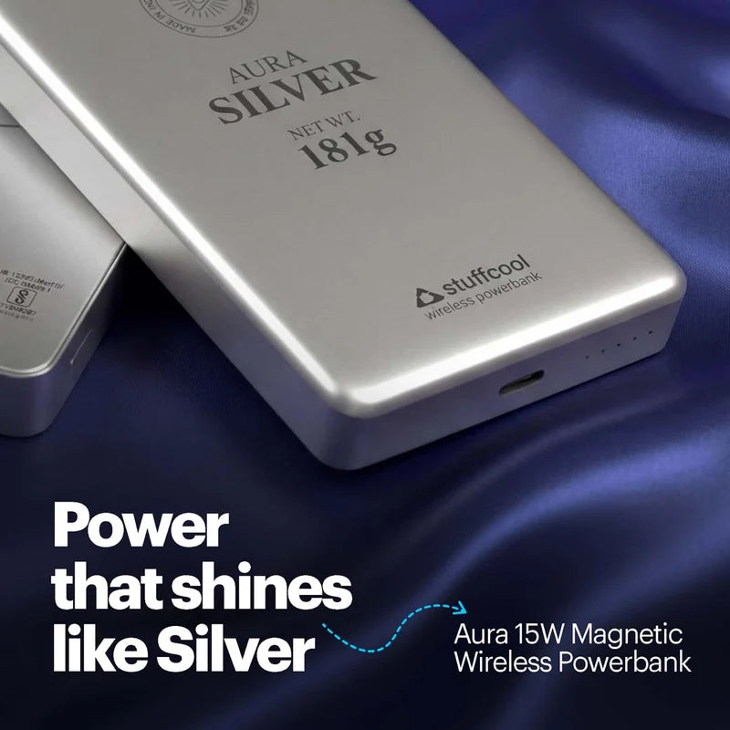 Silver wireless power bank with 'Stuffcool' branding on a blue fabric background
