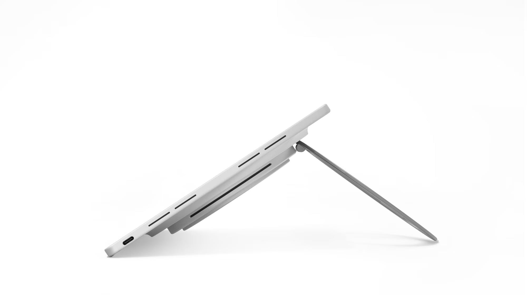 A silver Microsoft Surface Pro tablet shown at an angle with its kickstand extended, on a clean white background.
