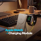 Foldable Apple Watch charging module on a desk with a keyboard and computer setup.