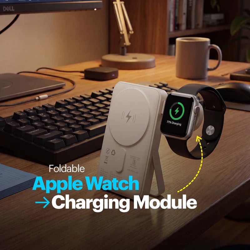 Foldable Apple Watch charging module on a desk with a keyboard and computer setup.