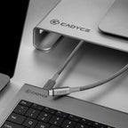 Cadyce USB-C hub attached to a laptop with a focus on the brand logo.