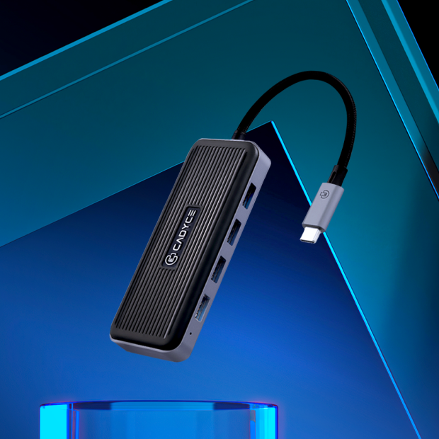 A black and silver USB-C hub with a ribbed top panel and a black USB-C cable, shown floating against a blue and black geometric background. The brand name 'Caviage' is printed on the side.