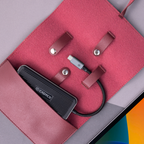 Caddy power bank and cable on a red surface with a colorful background