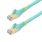 StarTech C6ASPAT15AQ 15ft Cat6a Shielded Ethernet Cable aqua cable coiled on a white surface