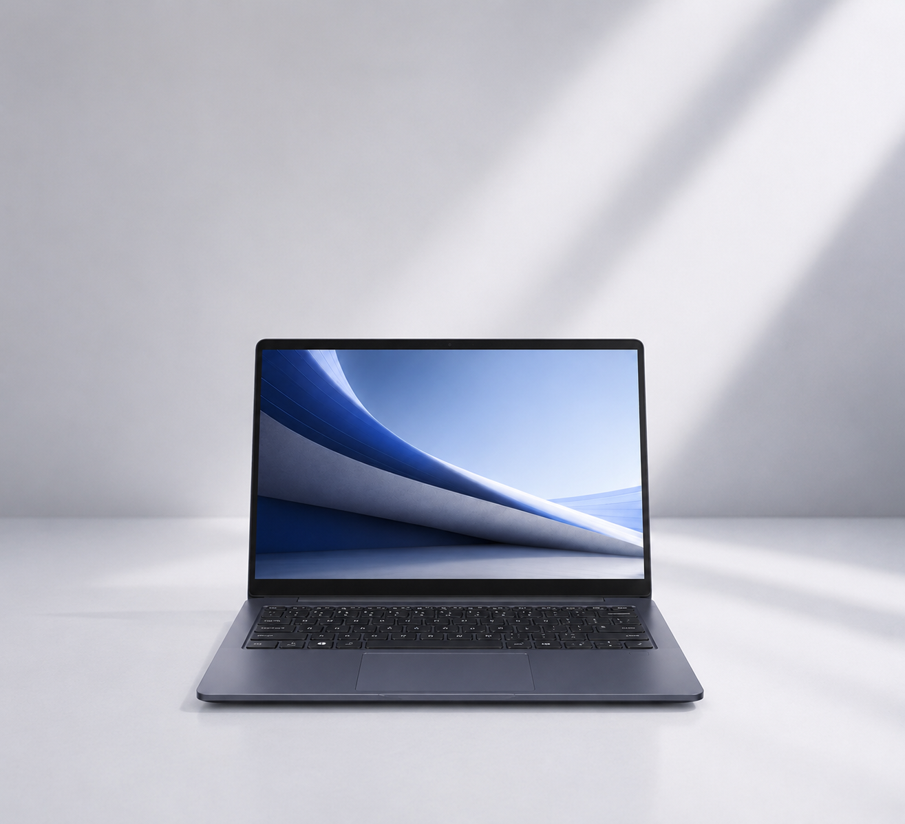 Laptop on a white surface with a light gray background