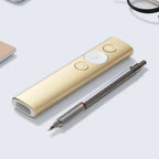 Gold electronic device with buttons and a pen on a light gray background