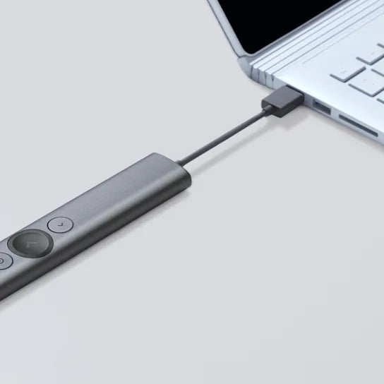 USB-C adapter connected to a laptop on a light gray background