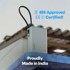 A silver Anker Powercrisis portable power bank with a black wrist strap, shown outdoors on a blue structure with a blurred roof in the background. Blue text overlays read 'BIS Approved', 'CE Certified!', and 'Proudly Made in India'.